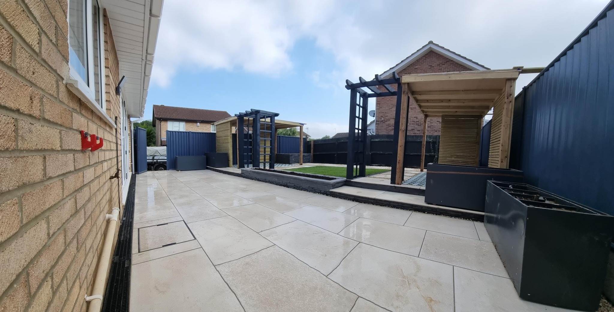 Beautifully landscaped garden with dual pergolas and porcelain paving by Cornerstone