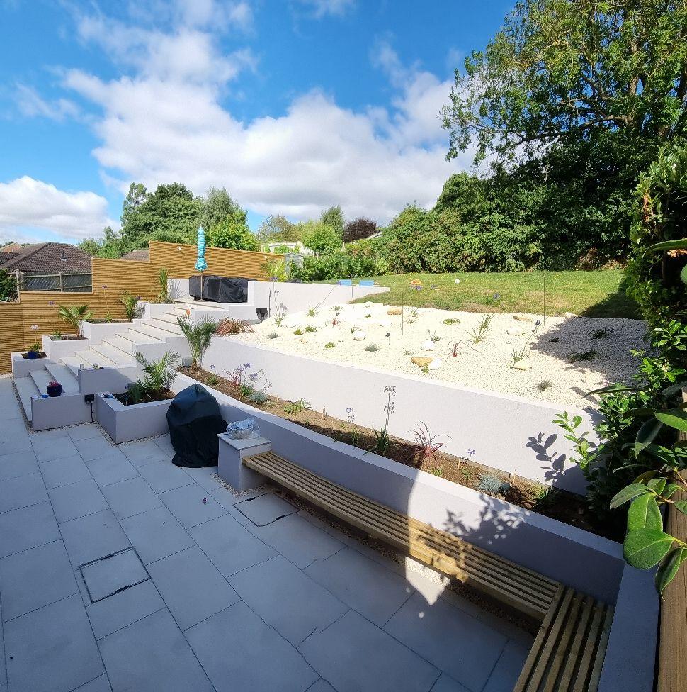 Tiered garden design with white retaining walls